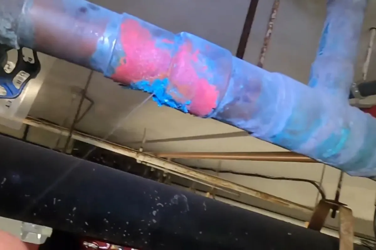 Burst supply pipe after a freeze, repaired in a Roswell, GA home