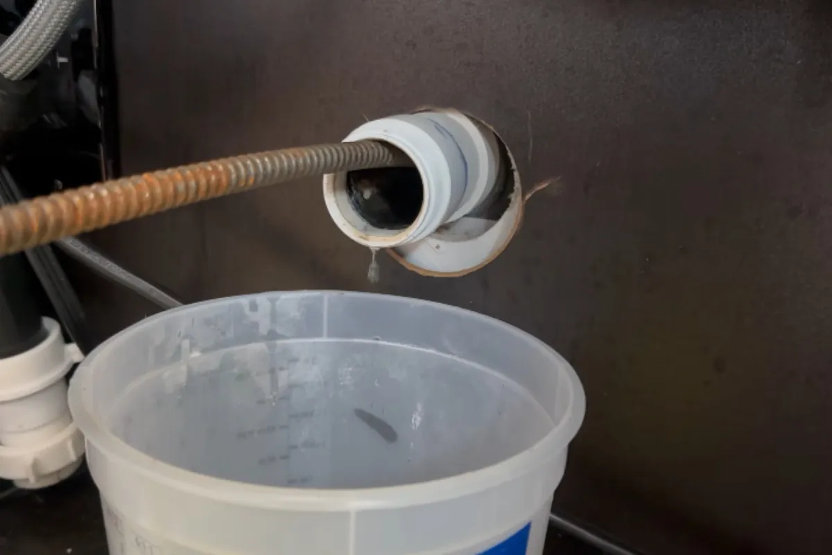 Drain cable feeding into a cleanout to clear a clogged drain in Roswell, GA