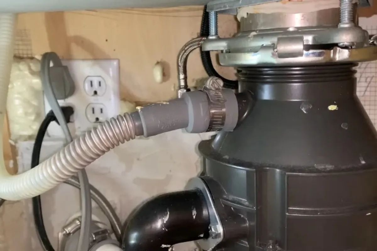 Garbage disposal and dishwasher connection under a kitchen sink in Roswell, GA