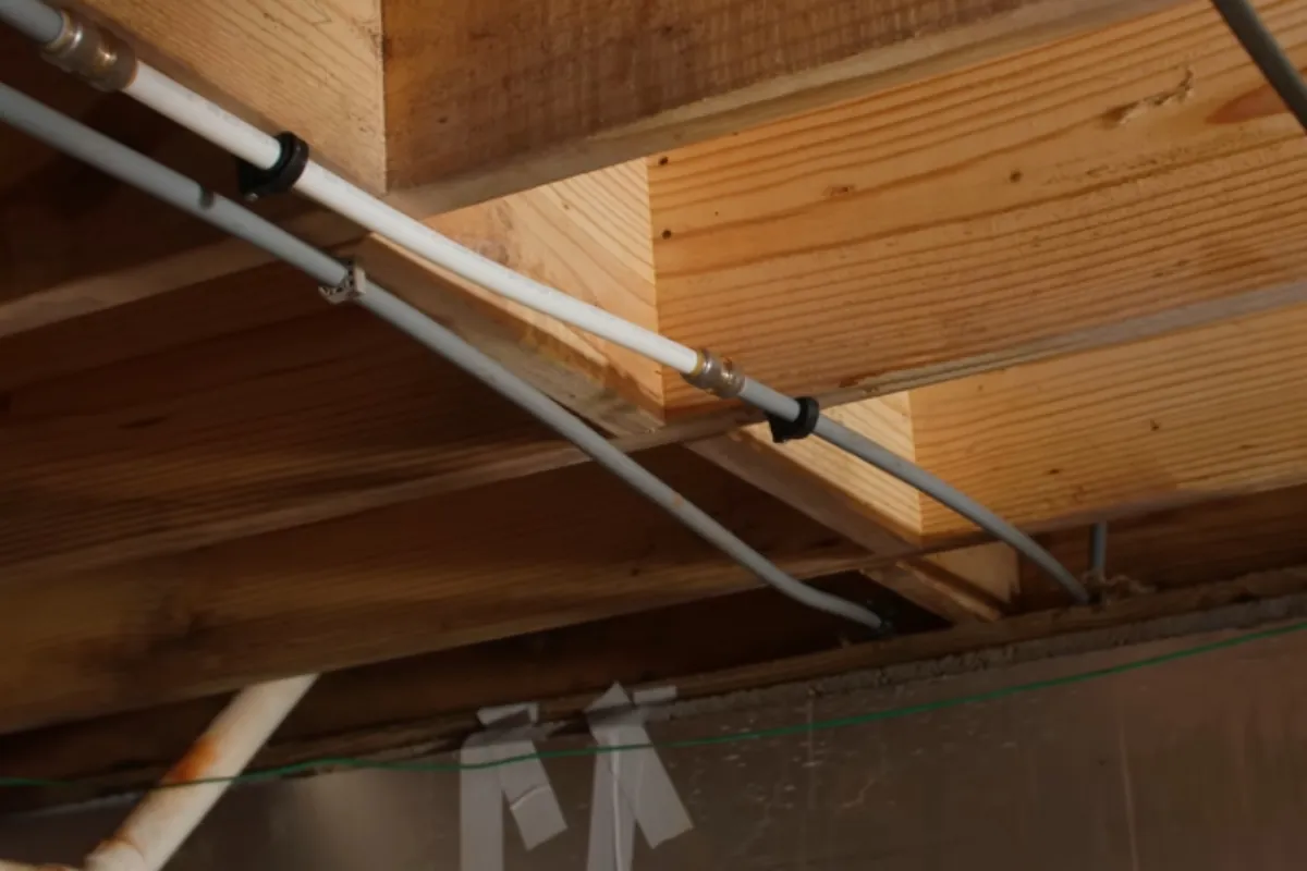 Gray polybutylene pipe being replaced with PEX during a whole-home repipe in Roswell, GA